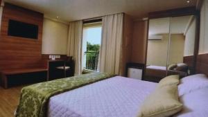 Giường trong phòng chung tại Condomínio Vista azul +16 ảnh