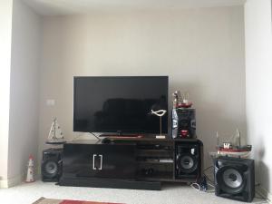 a entertainment center with a flat screen tv and speakers at Duplex Jacuzzi San Alfonso del Mar in Algarrobo