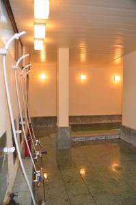 an empty room with lights on the walls and a pillar at 御宿しんしま in Matsuzaki