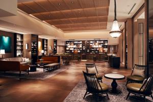 a lobby with a library with chairs and tables at The Prince Park Tower Tokyo - Preferred Hotels & Resorts, LVX Collection in Tokyo