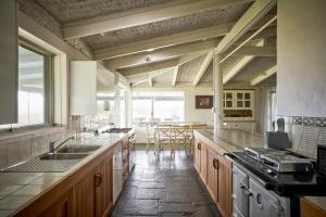 a large kitchen with wooden cabinets and a large window at Wandin Valley Estate in Lovedale