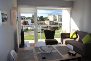 a living room with a couch and a table at Departamento Arrieros in Osorno +4 photos