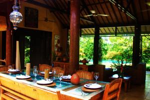 a dining room with a table with wine glasses at Villa Jeruk I 2 Bedrooms Umalas Canggu in Canggu