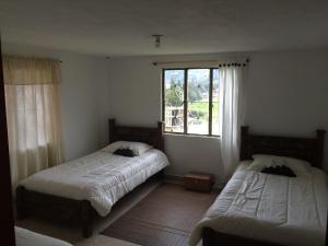 Postel nebo postele na pokoji v ubytování Hostal Casa Lantana