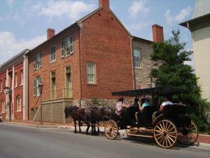 a group of people riding in a horse drawn carriage at A B&B at Llewellyn Lodge in Lexington +12 photos