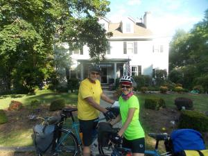 a man and woman standing with their bikes in front of a house at A B&B at Llewellyn Lodge in Lexington