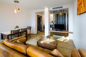 a living room with a leather couch and a table at Aiyara Palace in Pattaya North