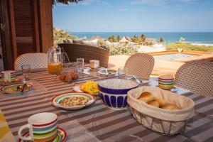 a table with food on it with a view of the ocean at Casa Safran Vichayito in Los Órganos