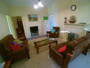 
a living room filled with furniture and a fire place at 12 Bluewater Drive in Kianga
