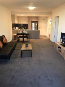 a living room with a couch and a table at Liverpool New Apt 2BR and 2Bath in Liverpool
