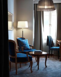 a living room with a chair and a table at Clarion Collection Hotel Smedjan in Sandviken
