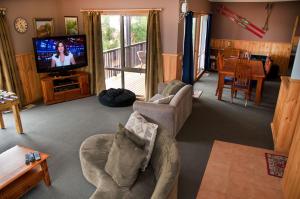 a living room with a couch and a television at Whistler in Bright