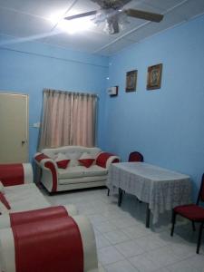 a living room with a couch and a table at Saujana Homestay in Ranau