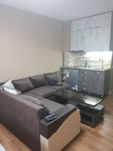 a living room with a couch and a kitchen at The valley 309 in Nariani