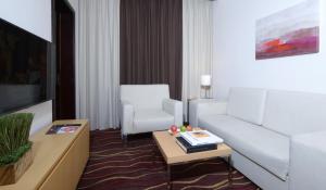 a living room with a couch and a table at ibis Seef Manama in Manama