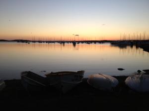 a group of boats sitting on the shore of a body of water at Aquarius Motel in Belmont +10 photos