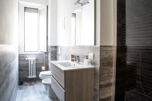 a bathroom with a sink and a toilet and a mirror at Mi Suzzani in Milan