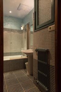 a bathroom with a sink and a toilet and a tub at Santa Ana B&B in Darnius +127 photos