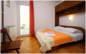 a bedroom with a bed with two towels on it at Apartments HULJEV in Primošten +34 photos