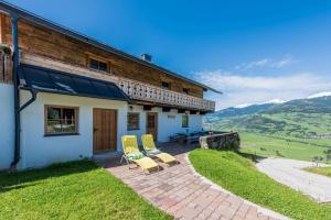 a house with two chairs and a patio at Almliesl PIES-533 in Piesendorf