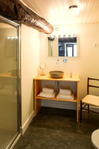 a bathroom with a sink and a shower at Casa Estrela Loft in Juncais