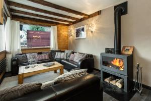 a living room with a couch and a fireplace at Chalet Aigle Royal in Chamonix
