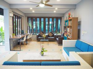 a living room with a couch and a table at Aonang Buri Resort- SHA Extra Plus in Ao Nang Beach