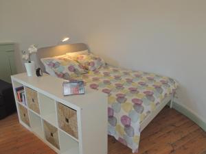 a bedroom with a bed with a dresser at La Tourelle in Saint-Agnan-sur-Sarthe