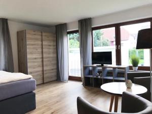 a living room with a couch and a table at Best Apartments in Bad Salzuflen