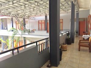 an empty lobby with plants in a building at Sola Gracia Guest House & Kost in Palangkaraya
