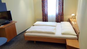 Letto o letti in una camera di CenterCourt Hotel