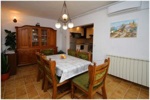 a dining room with a table and some chairs at Apartments HULJEV in Primošten