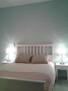a bedroom with a large bed with two lamps at Pop Art House Center 2 Bedrooms in Málaga