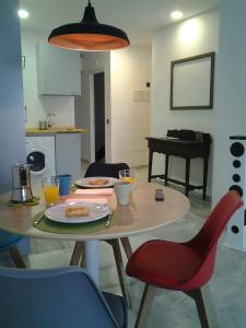 a table with a plate of food on top of it at Pop Art House Center 2 Bedrooms in Málaga