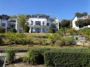 a house on a hill with bushes and trees at Appartement Residenz Bellevue Whg 22 in Zinnowitz