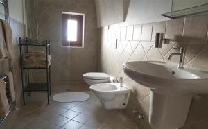 uma casa de banho com um lavatório branco e um WC. em Masseria Rosario em Grottaglie