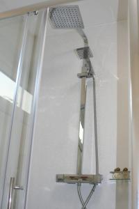a shower with a mirror in a bathroom at ABBEY HOLIDAY ACCOMMODATiON in Whitby +70 photos