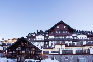 a large building with snow on the ground at Vincci Selección Rumaykiyya in Sierra Nevada