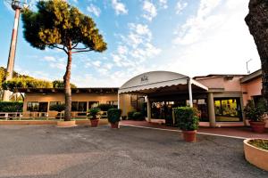 a building with a tree in front of it at Real Village Roma in Rome