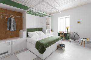 a bedroom with a bed and a desk and a chair at City Hotel Bortoli by Ribas in Odesa