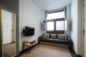 a living room with a couch and a window at Flatsforyou Turia in Valencia