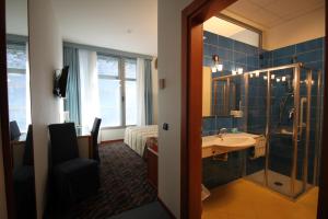 a bathroom with a sink and a shower and a mirror at Hotel San Terenzo in Lerici