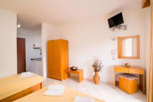 a living room with a table and a kitchen at Studios Maria in Potos