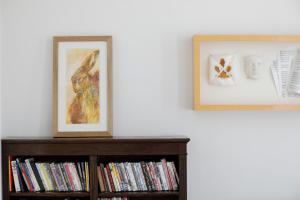 a book shelf with a picture and a painting on it at ALTIDO Cosy 1-bed flat in Angel, close to tube in London