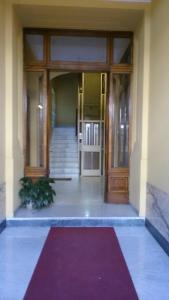 uma entrada para um edifício com um tapete vermelho na frente em Laterano Inn em Roma
