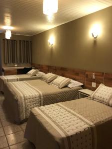 Cama ou camas em um quarto em Amoreiras Hotel Pousada