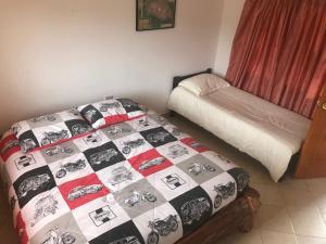 Postel nebo postele na pokoji v ubytování Hostal Casa Lantana