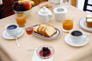 a table with a breakfast of cake and coffee and fruit at Noufara Hotel in Kamena Vourla