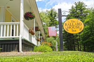 a house with a sign for the ballard house inn at Ballard House Inn in Meredith