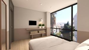 a bedroom with a bed and a large window at Great Living Apartments in Athens